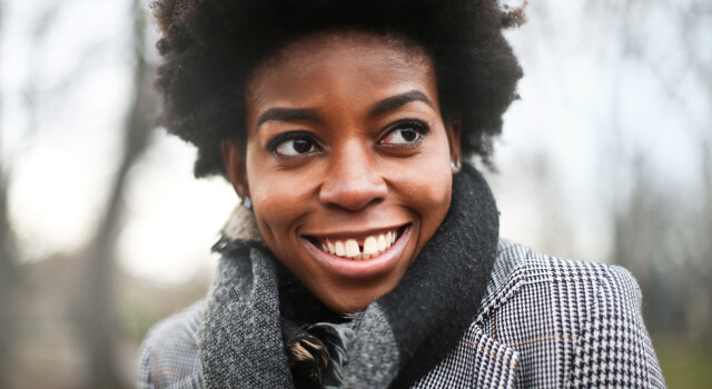 A young African woman posing outdoors